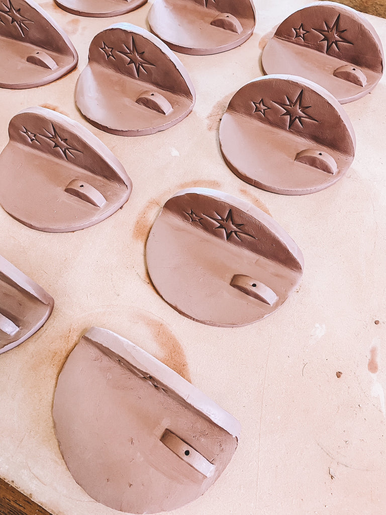 Set of ceramic cookie stamps with star designs on a white surface