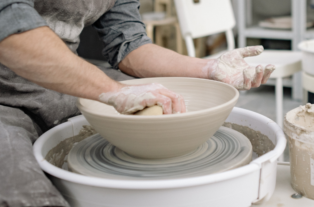 man making a mud bowl