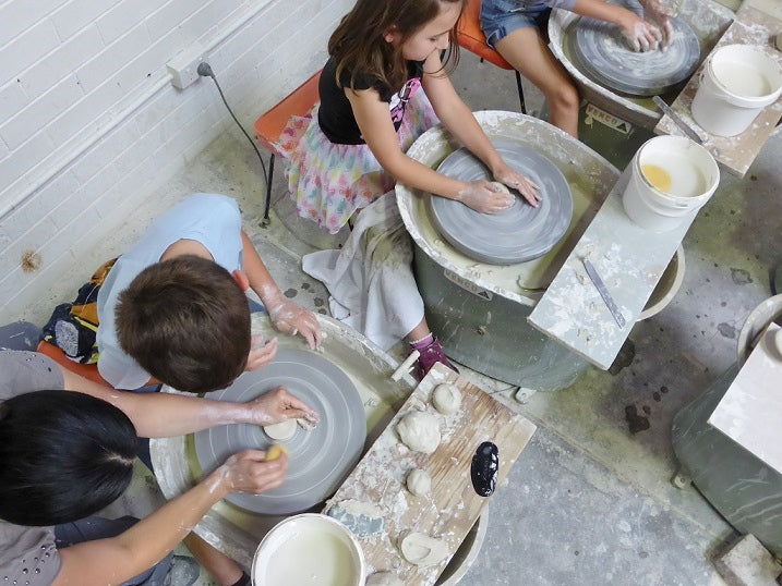 Kids try the wheel pottery
